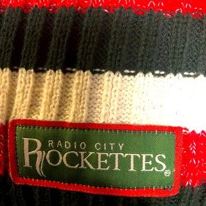 Radio city Rockettes scarf, colors are dark green, off white and a glittery red.